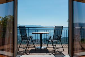 a table and chairs on a balcony with a view at Il Leccio - Luxury Resort Portofino Monte in Santa Margherita Ligure