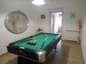 a room with a pool table and a mirror at B&B Marcello & Francesca in Urbino