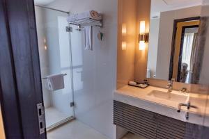 a bathroom with a shower and a sink and a mirror at Somerset Greenways Chennai in Chennai