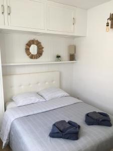 a bedroom with a bed with two towels on it at Villa L'Amiraute in Agde