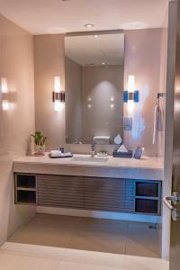 a bathroom with two sinks and a mirror at Somerset Greenways Chennai in Chennai