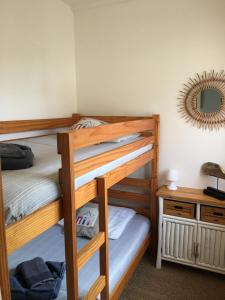 a bedroom with two bunk beds and a mirror at Villa L'Amiraute in Agde