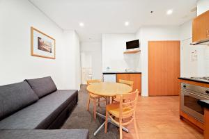 a living room with a couch and a table at All Suites Perth in Perth