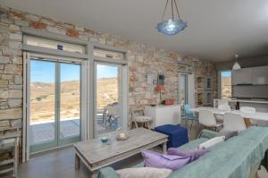 a living room with a couch and a table at Sunshine villa in Mikri Vigla