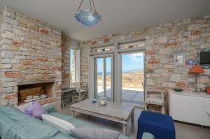 a living room with a stone wall at Sunshine villa in Mikri Vigla