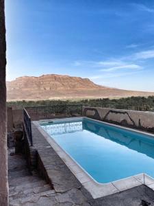 a swimming pool with a view of the desert at Kasbah Oulad Othmane in Agoubt