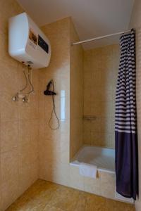 a bathroom with a shower and a bath tub at Apart Petrovskie on Sovetskaya 60 in Tomsk