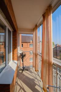 a balcony with a view of a building at Apart Petrovskie on Sovetskaya 60 in Tomsk