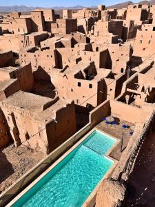 an aerial view of a village with a swimming pool at Kasbah Oulad Othmane in Agoubt