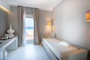 a hotel room with a bed and a window at Covo dei Saraceni in Polignano a Mare