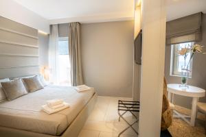 a bedroom with a bed with two towels on it at Covo dei Saraceni in Polignano a Mare