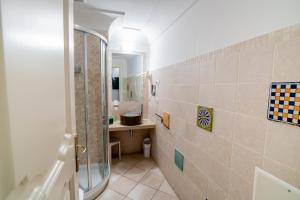 a bathroom with a shower and a sink and a mirror at Covo dei Saraceni in Polignano a Mare