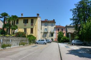 a street with cars parked on the side of a building at Casa Vacanze Stella in Verbania