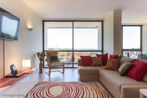 a living room with a couch and a flat screen tv at Cascais Panoramic Apartment in Cascais