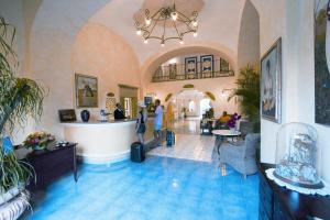a large room with a lobby with blue tiles at Hotel Terme Zi Carmela in Ischia