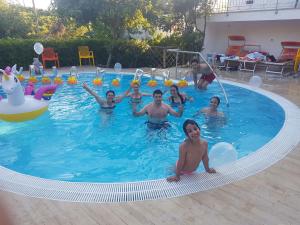 a group of people in a swimming pool at Aparthotel Villa Marinù in Ischia