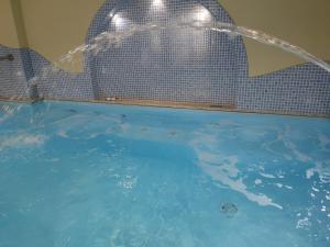 a large swimming pool with a water fountain at Aparthotel Villa Marinù in Ischia