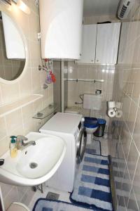 a small bathroom with a sink and a toilet at Casa Bohinj in Bohinj