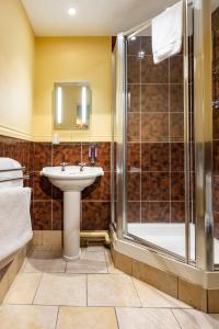 a bathroom with a sink and a shower at The Half Moon Inn and Country lodge in Yeovil