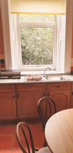 
a kitchen with a table and chairs and a window at Argyll Apartments in Glasgow
