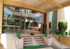 a large building with stairs and potted plants at Seven Sky Clarks Exotica in Bhuj