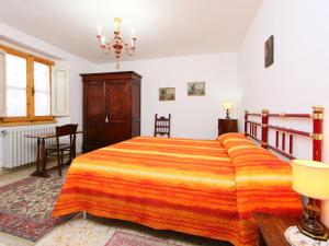 a bedroom with a large bed and a table at Apartment Matteuzzi by Interhome in Mercatale Val Di Pesa