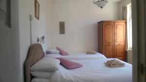 a bedroom with two beds with pink pillows on them at Legends Hotel in Blackpool