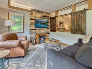 a living room with a couch and a fireplace at The Maples w/ King Bed in Ellicottville