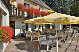バート・ミュンダー・アム・ダイスターにあるThemen Hotel Terrassen Cafeのパティオ(テーブル、椅子、パラソル付)
