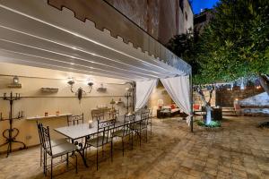 a patio with a table and chairs under a tent at Relais 147 - Luxury b&b in Taormina