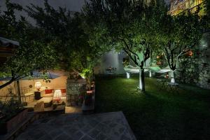 a garden with trees and a hammock in a building at Relais 147 - Luxury b&b in Taormina