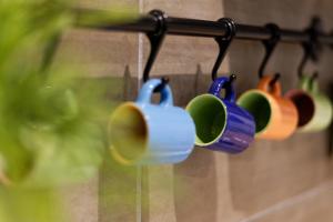 a group of coffee cups hanging from a rack at Marilù in Palermo