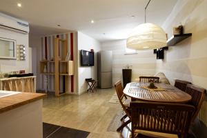 a kitchen and dining room with a table and chairs at Marilù in Palermo