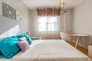 a bedroom with a large bed and a table at Teatro Nuovo Apartment with Free Parking in Udine