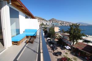a balcony with a view of a city and the water at Kristina Hotel in Sarandë