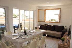 a living room with a table and a couch at Villa Korculaholidays in Zavalatica