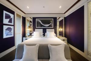 a bedroom with a large bed with white pillows at Seventy Barcelona in Barcelona