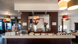 a kitchen with a counter top and a large mirror at Hotel Vale Do Navio in Capelas