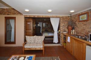 a kitchen with a sink and a chair in a room at IRONWOOD LODGE in Pennington