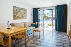 a living room with a couch and a table at Nautilus Lanzarote in Puerto del Carmen