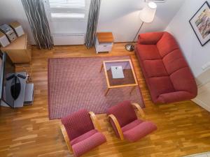 an overhead view of a living room with a couch and chairs at Holiday Home Alppitalo punatähti 7 apt 4 by Interhome in Tahkovuori