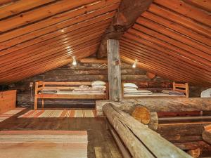 a room with two beds in a log cabin at Holiday Home Luostonseita 3 by Interhome in Luosto