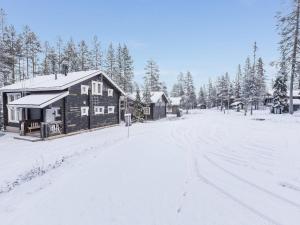 a log cabin in the snow with a road at Holiday Home Uuvana by Interhome in Äkäslompolo
