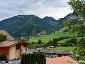 a small village with mountains in the background at Apartment Bijou Eggetli by Interhome in Zweisimmen
