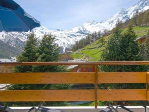 a balcony with a view of a snow covered mountain at Apartment Acimo by Interhome in Saas-Fee