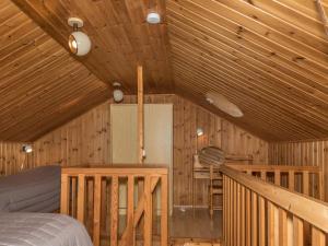 a bedroom with a bed and a wooden ceiling at Holiday Home Ylläskarpalo 3 päätyhuoneisto by Interhome in Äkäslompolo
