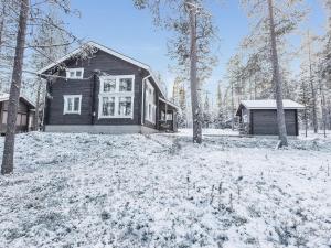 a house with snow on the ground in front at Holiday Home Uuvana by Interhome in Äkäslompolo