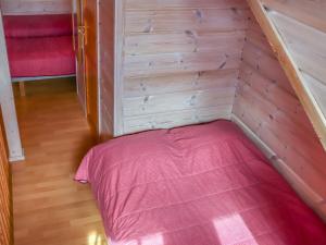 a small room with a bed in a wooden wall at Holiday Home Villa hytönen 2 by Interhome in Äkäslompolo +12 photos
