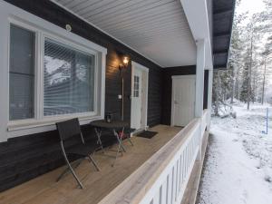 a porch of a house with a table and chairs at Holiday Home Pihkala 1 by Interhome in Äkäslompolo +17 photos