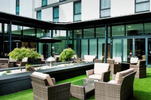 a green lawn chair sitting in front of a patio at Park Inn by Radisson Aberdeen in Aberdeen
